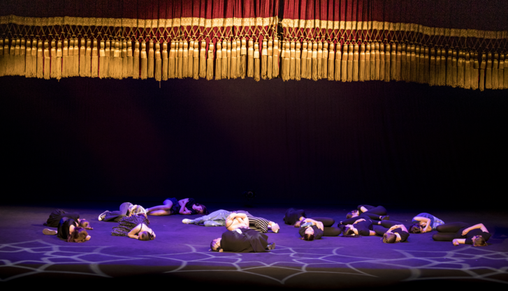 Na zdjęciu fragment kurtyny na dużej scenie teatru oraz aktorzy leżący na scenie